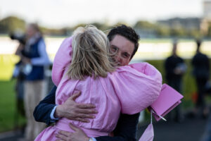 Racehorse Owner hugging winning jockey. 